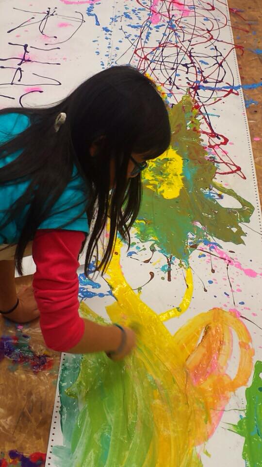 Girl painting on floor